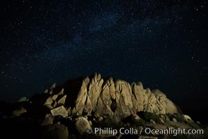 Rocks and Milky Way arching overhead, night sky and stars above, Joshua Tree National Park, California