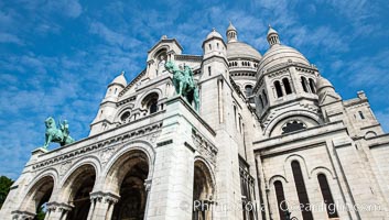 Sacre-Coeur Basilica. The Basilica of the Sacred Heart of Paris, commonly known as Sacre-Coeur Basilica, is a Roman Catholic church and minor basilica, dedicated to the Sacred Heart of Jesus, in Paris, France. A popular landmark, the basilica is located at the summit of the butte Montmartre, the highest point in the city, Sacr-Cur