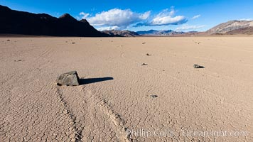 Sailing stone on the Racetrack Playa. The sliding rocks, or sailing stones, move across the mud flats of the Racetrack Playa, leaving trails behind in the mud. The explanation for their movement is not known with certainty, but many believe wind pushes the rocks over wet and perhaps icy mud in winter, Death Valley National Park, California