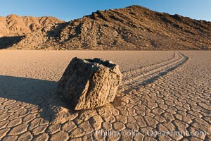 Sailing stone on the Racetrack Playa. The sliding rocks, or sailing stones, move across the mud flats of the Racetrack Playa, leaving trails behind in the mud. The explanation for their movement is not known with certainty, but many believe wind pushes the rocks over wet and perhaps icy mud in winter, Death Valley National Park, California