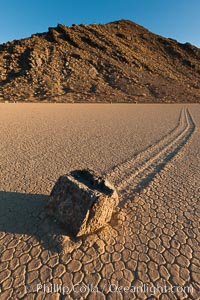 Sailing stone on the Racetrack Playa. The sliding rocks, or sailing stones, move across the mud flats of the Racetrack Playa, leaving trails behind in the mud. The explanation for their movement is not known with certainty, but many believe wind pushes the rocks over wet and perhaps icy mud in winter, Death Valley National Park, California