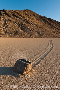 Sailing stone on the Racetrack Playa. The sliding rocks, or sailing stones, move across the mud flats of the Racetrack Playa, leaving trails behind in the mud. The explanation for their movement is not known with certainty, but many believe wind pushes the rocks over wet and perhaps icy mud in winter, Death Valley National Park, California