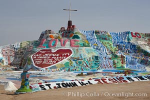 Salvation Mountain, near the desert community of Slab City and the small town of Niland on the east side of the Salton Sea.  Built over several decades by full-time resident Leonard Knight, who lives at the site, Salvation Mountain was built from over 100,000 gallons of paint, haybales, wood and metal and was created by Mr. Knight to convey the message that "God Loves Everyone"