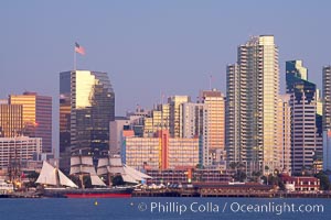 San Diego city skyline at dusk, viewed from Harbor Island, the Star of India at left