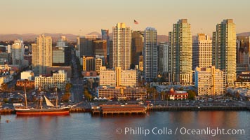 San Diego waterfront and skyline, Star of India (lower left), high rise modern office buildings, San Diego Bay, sunset