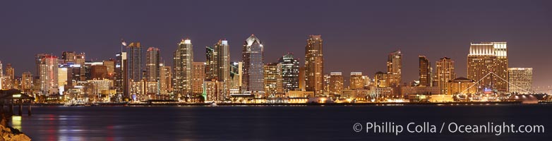 San Diego city skyline at sunset, showing the buildings of downtown San Diego rising above San Diego Harbor, viewed from Harbor Island.  A panoramic photograph, composite of four separate images.