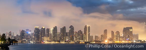 San Diego city skyline at sunrise, showing the buildings of downtown San Diego rising above San Diego Harbor, viewed from Harbor Island