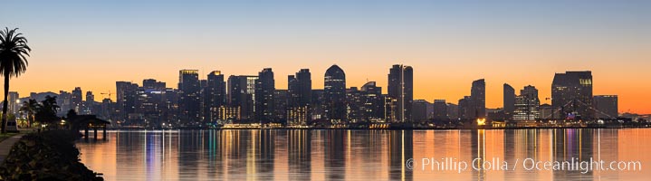 San Diego city skyline at sunrise, showing the buildings of downtown San Diego rising above San Diego Harbor, viewed from Harbor Island