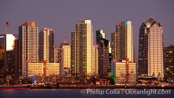 San Diego city skyline at sunset, showing the buildings of downtown San Diego rising above San Diego Harbor, viewed from Harbor Island.