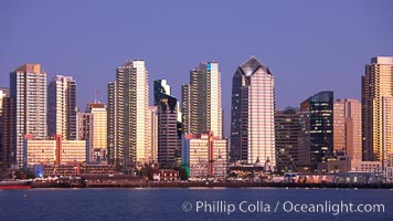 San Diego city skyline at sunset, showing the buildings of downtown San Diego rising above San Diego Harbor, viewed from Harbor Island