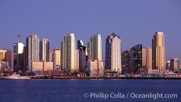 San Diego city skyline at sunset, showing the buildings of downtown San Diego rising above San Diego Harbor, viewed from Harbor Island