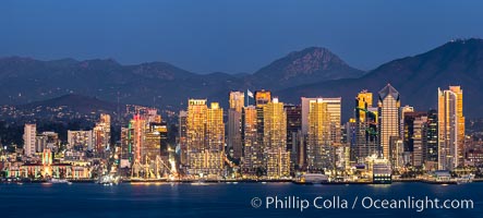 San Diego City Skyline at Sunset, viewed from Point Loma, panoramic photograph. The mountains east of San Diego can be clearly seen when the air is cold, dry and clear as it is in this photo. Lyons Peak is in center and the flanks of Mount San Miguel to the right