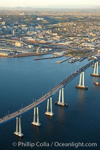 San Diego Coronado Bridge, known locally as the Coronado Bridge, links San Diego with Coronado, California.  The bridge was completed in 1969 and was a toll bridge until 2002.  It is 2.1 miles long and reaches a height of 200 feet above San Diego Bay.  Coronado Island is to the left, and downtown San Diego is to the right in this view looking north.