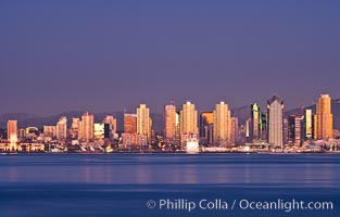 San Diego downtown city skyline and waterfront, sunset reflections and San Diego Bay. Earth-shadow (Belt of Venus) visible in the atmosphere