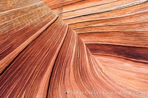 The Wave, an area of fantastic eroded sandstone featuring beautiful swirls, wild colors, countless striations, and bizarre shapes set amidst the dramatic surrounding North Coyote Buttes of Arizona and Utah.  The sandstone formations of the North Coyote Buttes, including the Wave, date from the Jurassic period. Managed by the Bureau of Land Management, the Wave is located in the Paria Canyon-Vermilion Cliffs Wilderness and is accessible on foot by permit only