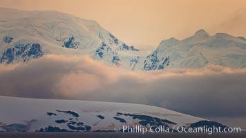 Scenery in Gerlache Strai.  Clouds, mountains, snow, and ocean, at sunset in the Gerlache Strait, Antarctica