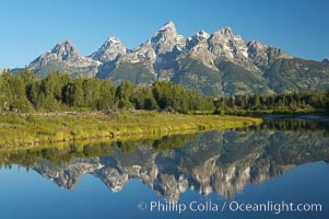 The Teton Range is reflected in the glassy waters of the Snake River at Schwabacher Landing, Grand Teton National Park, Wyoming