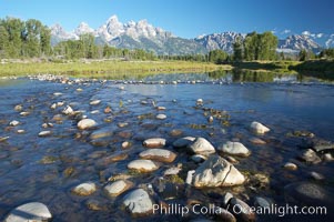 The Teton Range rises above river rocks in the Snake River at Schwabacher Landing, Grand Teton National Park, Wyoming