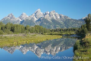 The Teton Range is reflected in the glassy waters of the Snake River at Schwabacher Landing, Grand Teton National Park, Wyoming