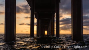 Scripps Pier, Surfer's view from among the waves. Research pier at Scripps Institution of Oceanography SIO, sunset, La Jolla, California