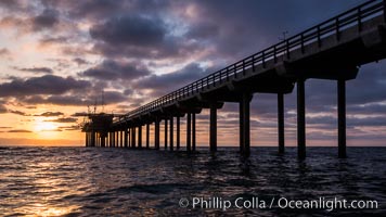 Scripps Pier, Surfer's view from among the waves. Research pier at Scripps Institution of Oceanography SIO, sunset.