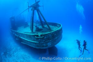 SCUBA divers on the wreck of the USS Kittiwake, sunk off Seven Mile Beach on Grand Cayman Island to form an underwater marine park and dive attraction