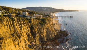 Scripps Beach Sea Cliffs and mushroom house, aerial photo. Mushroom House with its private elevator. Scripps Pier, Scripps Institution of Oceanography, and Mount Soledad in the distance, La Jolla, California