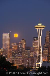 Full moon rises over Seattle city skyline, Space Needle at right