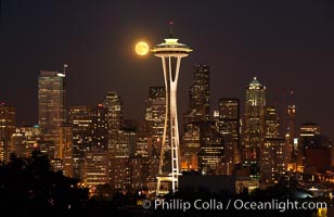 Full moon rises over Seattle city skyline, Space Needle at right