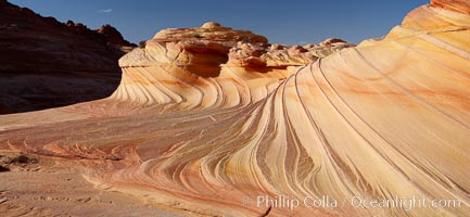 The Second Wave at sunset.  The Second Wave, a curiously-shaped sandstone swirl, takes on rich warm tones and dramatic shadowed textures at sunset.  Set in the North Coyote Buttes of Arizona and Utah, the Second Wave is characterized by striations revealing layers of sedimentary deposits, a visible historical record depicting eons of submarine geology, Paria Canyon-Vermilion Cliffs Wilderness