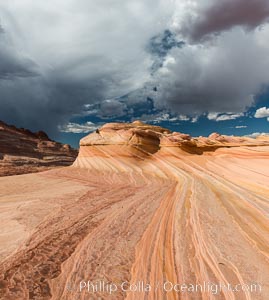 The Second Wave at sunset. The Second Wave, a curiously-shaped sandstone swirl, takes on rich warm tones and dramatic shadowed textures at sunset. Set in the North Coyote Buttes of Arizona and Utah, the Second Wave is characterized by striations revealing layers of sedimentary deposits, a visible historical record depicting eons of submarine geology