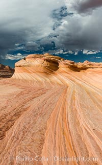 The Second Wave at sunset. The Second Wave, a curiously-shaped sandstone swirl, takes on rich warm tones and dramatic shadowed textures at sunset. Set in the North Coyote Buttes of Arizona and Utah, the Second Wave is characterized by striations revealing layers of sedimentary deposits, a visible historical record depicting eons of submarine geology, Paria Canyon-Vermilion Cliffs Wilderness