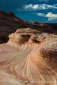 The Second Wave at sunset. The Second Wave, a curiously-shaped sandstone swirl, takes on rich warm tones and dramatic shadowed textures at sunset. Set in the North Coyote Buttes of Arizona and Utah, the Second Wave is characterized by striations revealing layers of sedimentary deposits, a visible historical record depicting eons of submarine geology, Paria Canyon-Vermilion Cliffs Wilderness