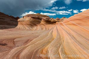 The Second Wave at sunset. The Second Wave, a curiously-shaped sandstone swirl, takes on rich warm tones and dramatic shadowed textures at sunset. Set in the North Coyote Buttes of Arizona and Utah, the Second Wave is characterized by striations revealing layers of sedimentary deposits, a visible historical record depicting eons of submarine geology, Paria Canyon-Vermilion Cliffs Wilderness