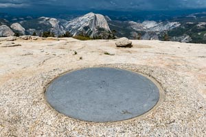Sentinel Dome summit compass marker, with Half Dome in the distance, Yosemite National Park