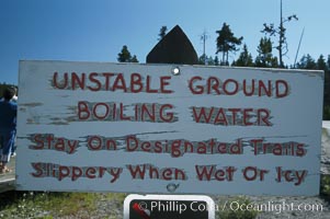 A sign warns Yellowstone visitors to beware of geysers, hot springs and superheated pools. Occasionally, park visitors are injured or killed falling into these dangerous geothermal features, Yellowstone National Park, Wyoming