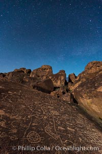 Sky Rock at night, light by moonlight with stars in the clear night sky above.  Sky Rock petroglyphs near Bishop, California. Hidden atop an enormous boulder in the Volcanic Tablelands lies Sky Rock, a set of petroglyphs that face the sky. These superb examples of native American petroglyph artwork are thought to be Paiute in origin, but little is known about them