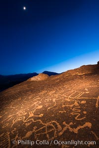 Sky Rock at night, light by moonlight with stars in the clear night sky above.  Sky Rock petroglyphs near Bishop, California. Hidden atop an enormous boulder in the Volcanic Tablelands lies Sky Rock, a set of petroglyphs that face the sky. These superb examples of native American petroglyph artwork are thought to be Paiute in origin, but little is known about them