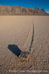 A sliding rock of the Racetrack Playa.  The sliding rocks, or sailing stones, move across the mud flats of the Racetrack Playa, leaving trails behind in the mud.  The explanation for their movement is not known with certainty, but many believe wind pushes the rocks over wet and perhaps icy mud in winter, Death Valley National Park, California