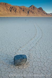 A sliding rock of the Racetrack Playa.  The sliding rocks, or sailing stones, move across the mud flats of the Racetrack Playa, leaving trails behind in the mud.  The explanation for their movement is not known with certainty, but many believe wind pushes the rocks over wet and perhaps icy mud in winter, Death Valley National Park, California