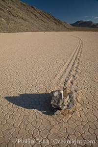 A sliding rock of the Racetrack Playa.  The sliding rocks, or sailing stones, move across the mud flats of the Racetrack Playa, leaving trails behind in the mud.  The explanation for their movement is not known with certainty, but many believe wind pushes the rocks over wet and perhaps icy mud in winter, Death Valley National Park, California