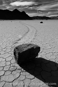 A sliding rock of the Racetrack Playa.  The sliding rocks, or sailing stones, move across the mud flats of the Racetrack Playa, leaving trails behind in the mud.  The explanation for their movement is not known with certainty, but many believe wind pushes the rocks over wet and perhaps icy mud in winter, Death Valley National Park, California