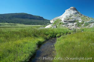 Soda Butte. This travertine (calcium carbonate) mound was formed more than a century ago by a hot spring. Only small amounts of hydrothermal water and hydrogen sulfide gas currently flow from this once more prolific spring, Yellowstone National Park, Wyoming