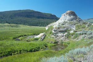 Soda Butte. This travertine (calcium carbonate) mound was formed more than a century ago by a hot spring. Only small amounts of hydrothermal water and hydrogen sulfide gas currently flow from this once more prolific spring, Yellowstone National Park, Wyoming