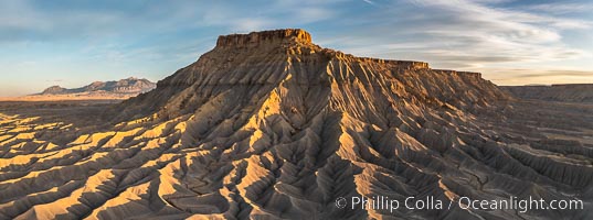 South Caineville Mesa, exceptional example of badlands erosional geology, near Hanksville, Utah.  The Henry Mountains lie in the distance.  Sunset