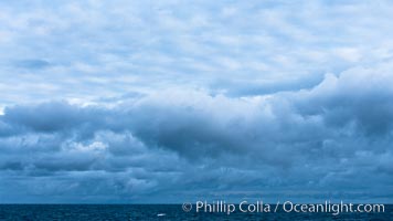 Clouds, weather and light mix in neverending forms over the open ocean of Scotia Sea, in the Southern Ocean