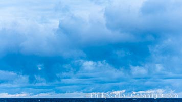 Clouds, weather and light mix in neverending forms over the open ocean of Scotia Sea, in the Southern Ocean