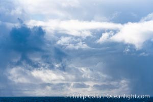 Clouds, weather and light mix in neverending forms over the open ocean of Scotia Sea, in the Southern Ocean