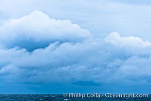 Clouds, weather and light mix in neverending forms over the open ocean of Scotia Sea, in the Southern Ocean