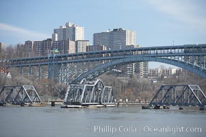 Spuyten Duyvil Swing Bridge (foreground) and Henry Hudson Bridge (background).  The Spuyten Duyvil Bridge is a swing bridge that carries Amtrak's Empire Corridor line across the Spuyten Duyvil Creek between Manhattan and the Bronx, in New York City. The bridge is located at the point where Spuyten Duyvil Creek and the Hudson River meet